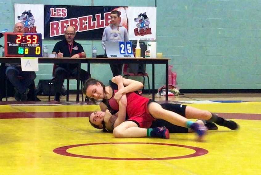 Tantramar Titan Kara Steeves, top, is shown competing at last month’s New Brunswick Interscholastic Athletic provincial wrestling championships. Kara brought home the gold medal in her weight class.