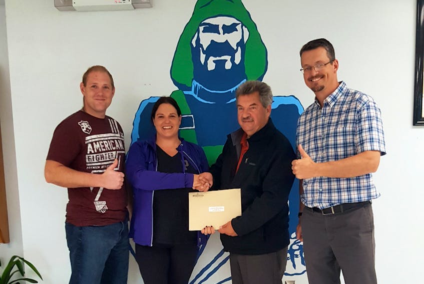 Memramcook-Tantramar MLA Bernard LeBlanc, second from right, presents members of the Port Elgin Regional Home and School Association with funding that will be used for new playground structures. PHOTO SUBMITTED