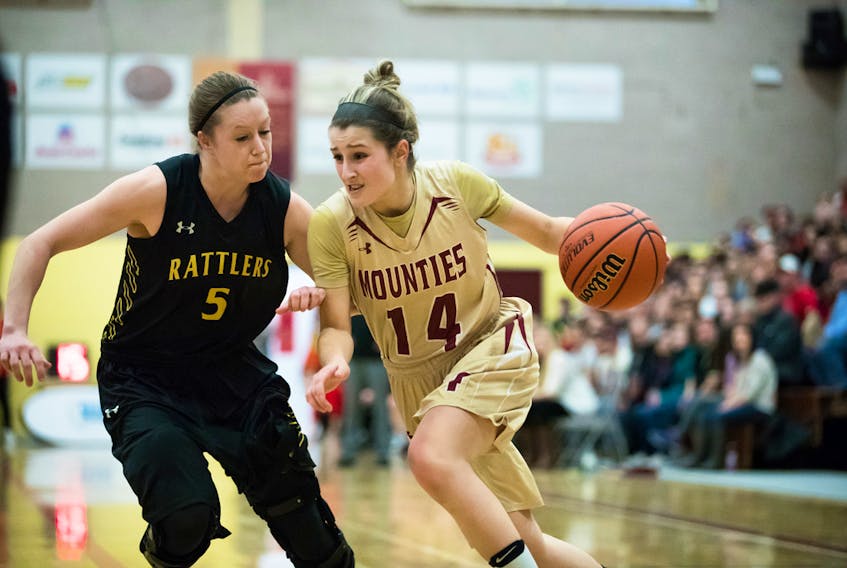 The Mounties' Karly Buckingham drives for the hoop against the Rattlers' Kendall Kuntz on Thursday evening.