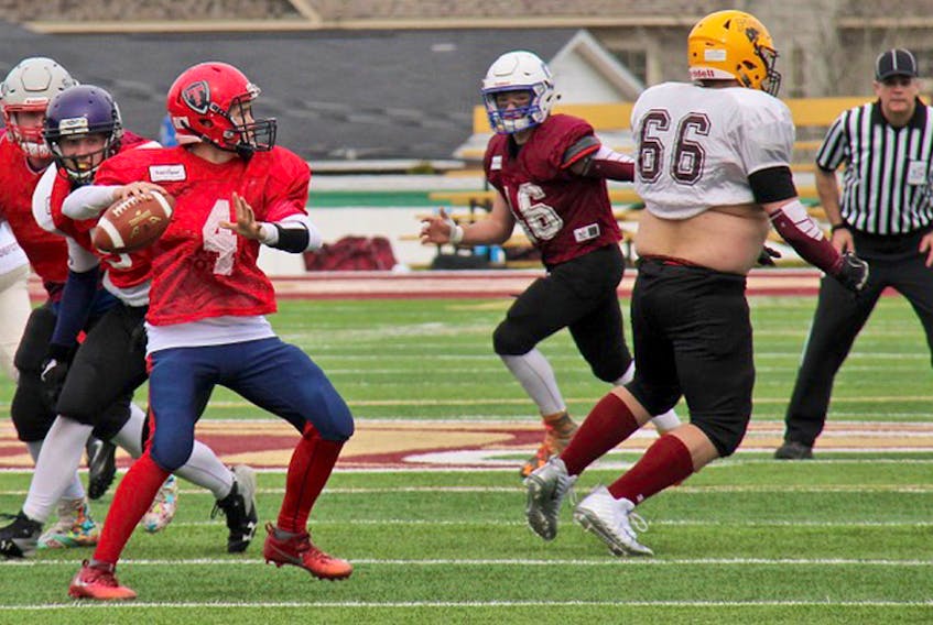 Tantramar Titan quarterback Justin Vogels looks downfield for a receiver during a U-18 showcase game held on Alumni Field in Sackville on Sunday, May 6.