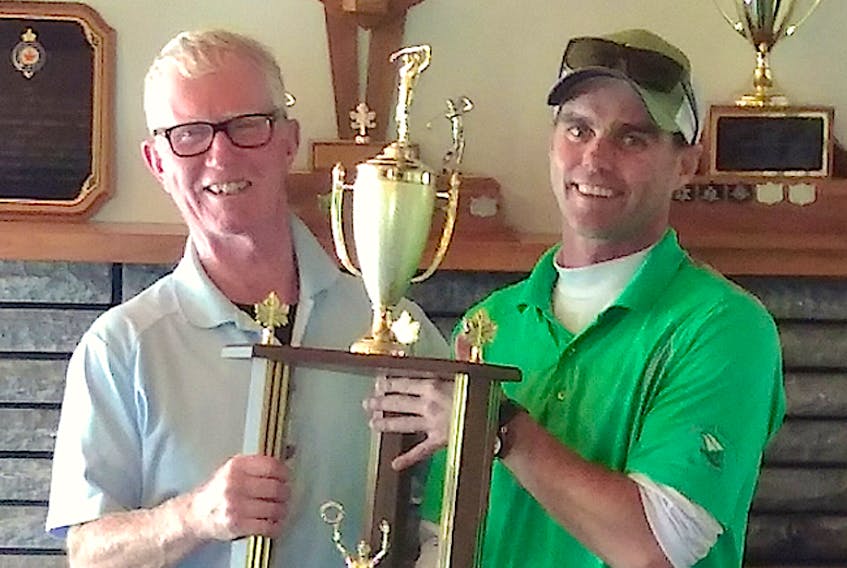As winner of the Sackville Golf and Country Club's annual championship, Travis Colwell, right, accepts the tournament trophy from club president Stephen Boorne on Sept. 9, 2018.