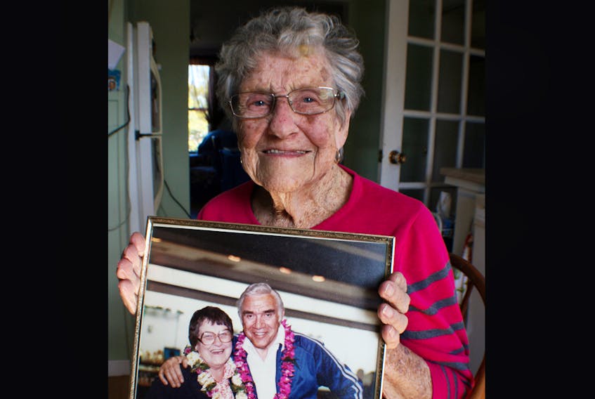 Centenarian Nettie Wells did some travelling in past years, visiting places such as Japan, South Korea and Switzerland. In this photo taken recently, she holds a photo taken of her and the late Canadian actor Lorne Green after the two had been seatmates on an airline flight to Hawaii.