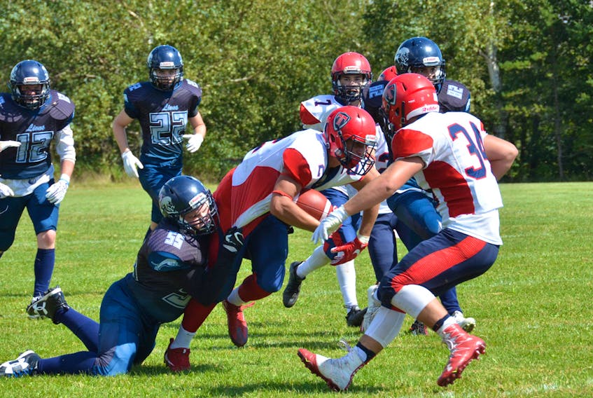 Sackville’s Lucas Cormier, shown above driving for extra yards as a member of the Tantramar Regional High School football Titans last season, played a role Canada’s U18 team defeat their counterparts from the U.S. in Arlington, Texas, last week.