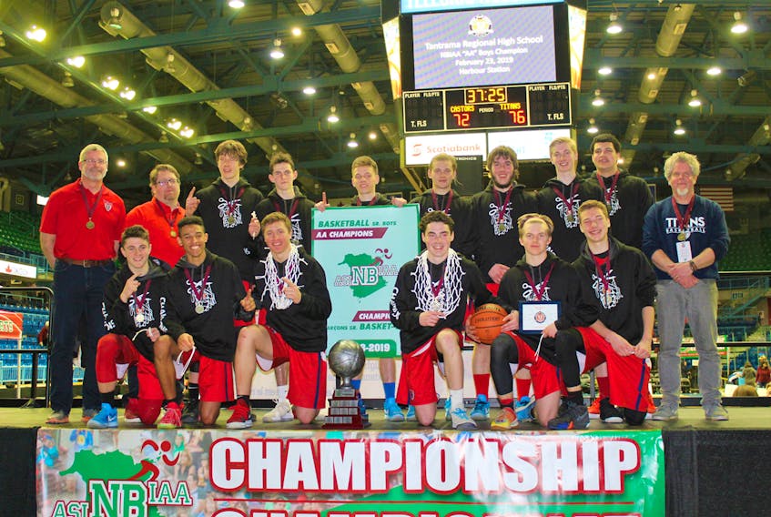 The Tantramar Regional High School men’s varsity team brought home the 2018-19 NBIAA AA basketball championship over the weekend, downing Ecole Sainte-Anne 76-72. Above, the Titans celebrate with the banner and their gold medals. – ANDREW SWANSON PHOTO