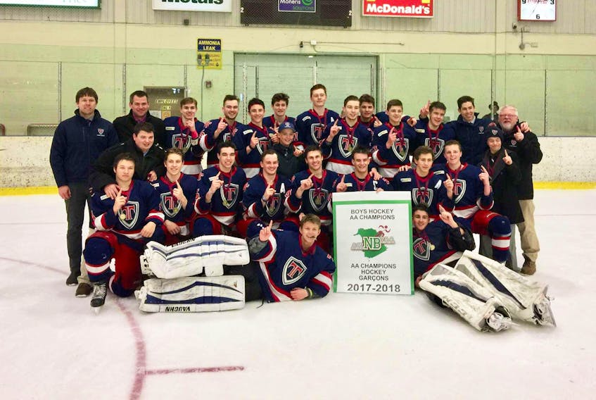 The Tantramar Titans pose with their provincial championship banner Sunday afternoon.