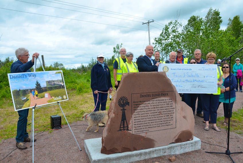 Members of the Sackville Rotary Club present a cheque for $25,200 to Sackville Mayor John Higham during an unveiling ceremony of the new Daniel Lund Park. The funds will be used for the construction of a bridge that will link the new park to the iconic Sackville Waterfowl Park.