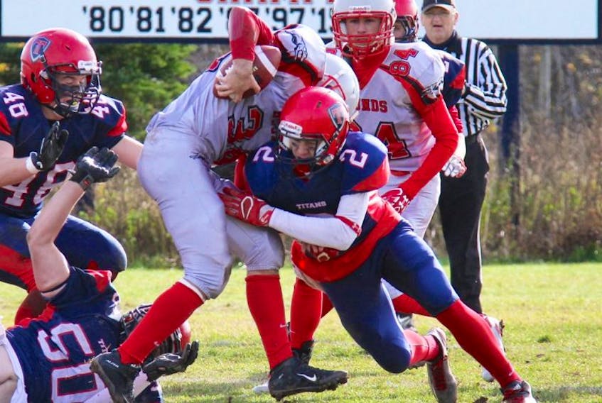 Titan Lucas Cormier takes down a Saint John opponent during his team’s 41-0 provincial semi-final win on Saturday.