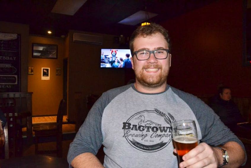 Bagtown Brewing Company president Robbie Baxter enjoys a glass during the new company’s official launch at Ducky’s Bar Saturday evening.
