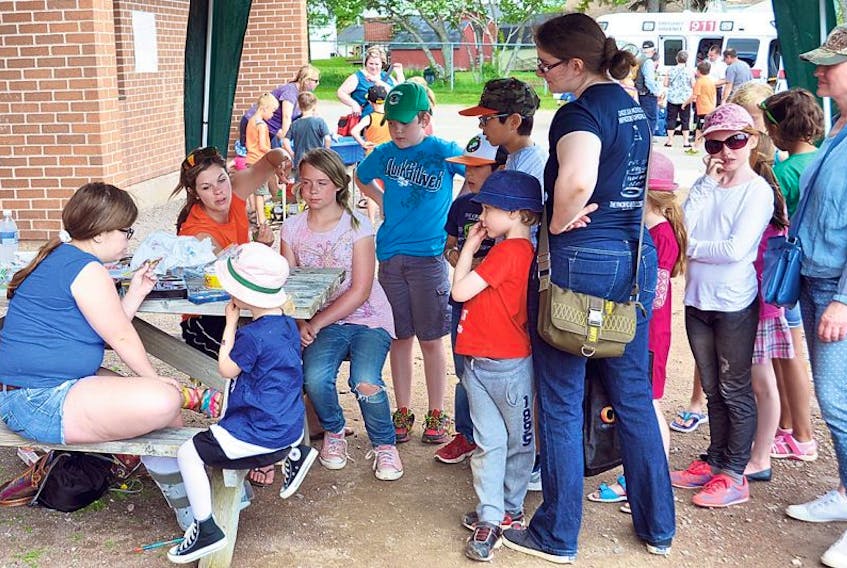 The fifth annual Salem Summer Send-Off takes place tomorrow (June 17). Above, children in a previous event line up for the face painting booth.