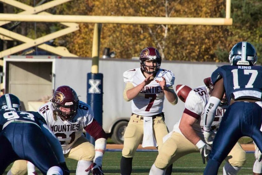 Mount Allison starting quarterback Jakob Loucks was taken to hospital by ambulance in Saturday's Loney Bowl in Antigonish but delighted fans by returning to finish the game after being checked out.