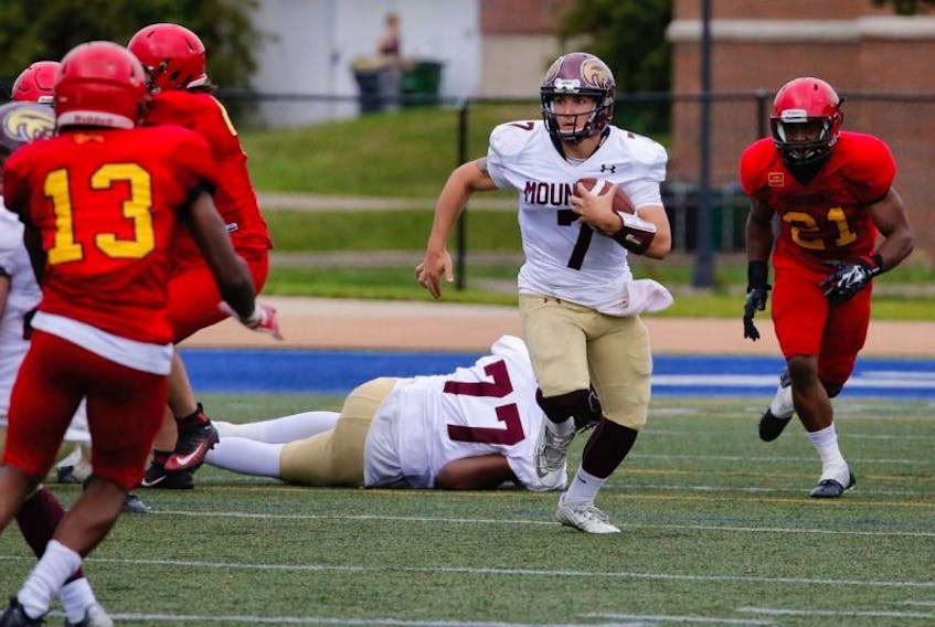 Mountie quarterback Jakob Loucks runs the ball in one of Saturday’s games against the Guelph Gryphons.