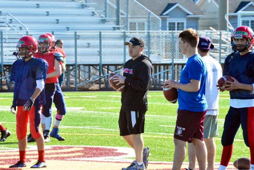 Mount Allison head football coach Scott Brady – shown above in the centre while helping coach during the annual Sackville Minor Football and Tantramar Regional High School spring training camp – will see his squad face off against the St. FX X-Men and Guelph Gryphons in Antigonish on Aug. 19 during an event that will feature six mini-games over the course of the afternoon.