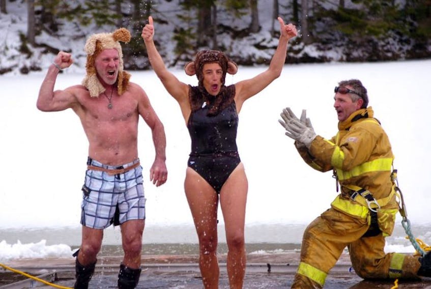 The 2016 Dorchester Lions Club Polar Dip went off without a hitch on Friday, Jan. 1, at Palmer’s Pond, with nearly 50 people taking the plunge and a crowd of about 100 people coming out to watch the festivities. Above, Sylvain Lederc and Ana Berlie celebrate after welcoming the new year with an icy plunge, while Dorchester firefighter Reg Tower applauds their efforts.