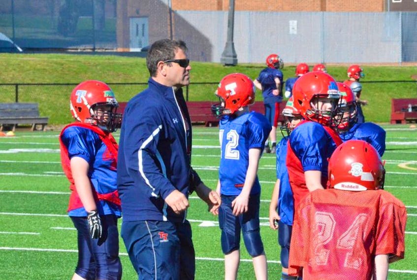 Tantramar Regional High School head coach Scott O’Neal, shown above working with minor level players at this year’s spring training camp, says the recent announcement that three of his players will join national all-star teams reflects well on the school and what is trying to be accomplished with the local football program.