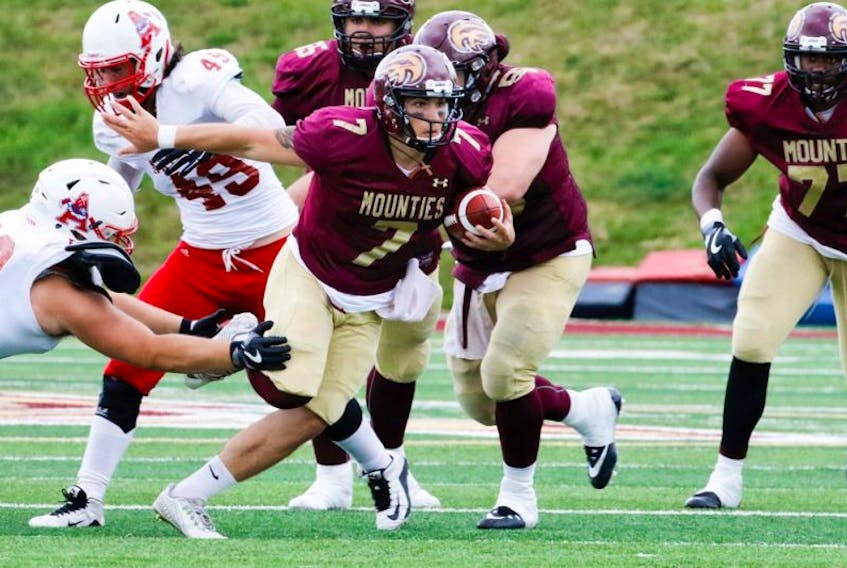 Mountie quarterback Jakob Loucks, shown above running the ball in Saturday’s season opener against Acadia, was the team’s leading rusher with 53 yards. Loucks has been named the week 1 Atlantic University Sport offensive player of the week.