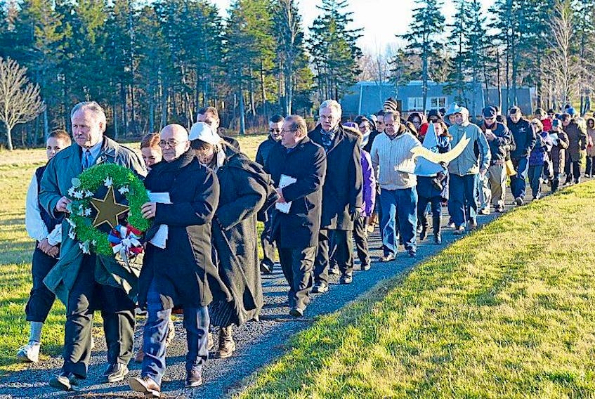 <span class="Normal">Societe Saint-Thomas-d'Aquin president Guy LaBonté, from left, and Société Nationale de l'Acadie president René Cormier lead a procession to the Acadian Odyssey Monument at Port-la-Joye and Fort Amherst National Historic Site. About 100 took part in the eight annual Acadian Remembrance Day ceremony to commemorate those who suffered during the 1758 expulsion. <br /></span>
