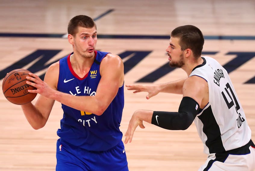 Nuggets centre Nikola Jokic is guarded by Clippers' Ivica Zubac.