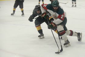 Charlottetown Bulk Carriers Knights' defenceman Landon MacDonald, left, knocks the puck away from Kensington Monaghan Farms Wild captain Will Proud during major midget playoff action earlier this year.
File