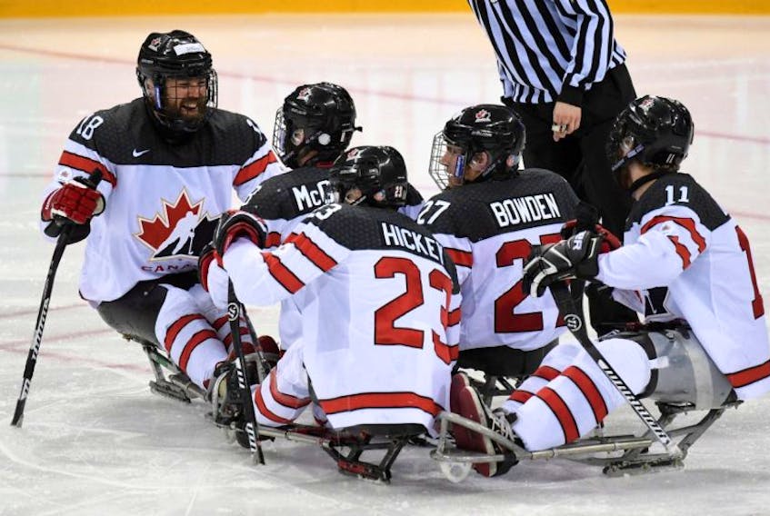Members of Team Canada's para hockey team, including Liam Hickey (23) of St. John's, celebrate a goal on their way to defeating the United States 4-1 in the gold-nedal game at the world para hockey championship in Gangenung, South Korea on Thursday.
