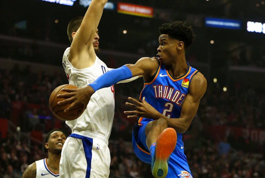 Oklahoma City Thunder point guard  Shai Gilgeous-Alexander passes around Los Angeles Clippers' Ivica Zubac. (GETTY IMAGES)