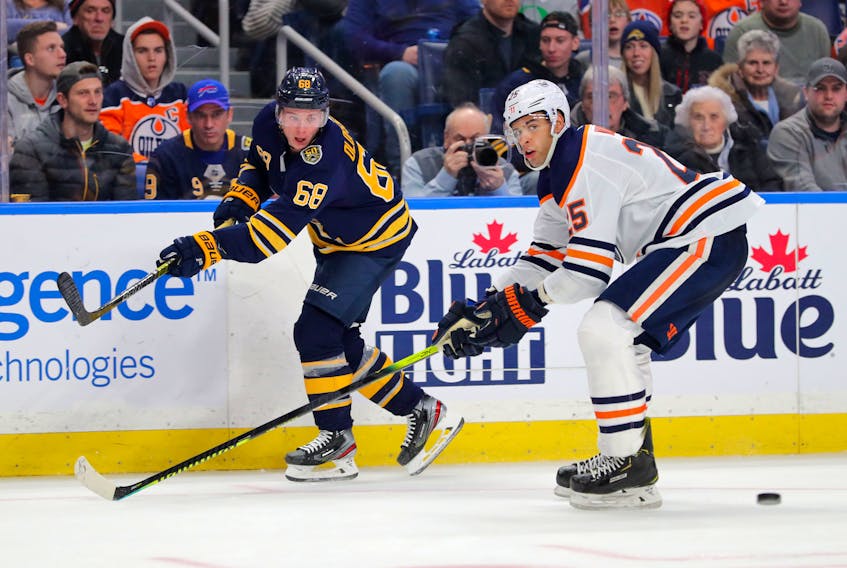 Edmonton Oilers' Darnell Nurse tries to block a pass by Buffalo Sabres' Victor Olofsson last month. (GETTY IMAGES)