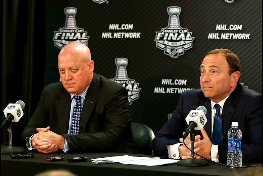 FILE PHOTO: NHL deputy commissioner Bill Daly (left) and NHL Commissioner Gary Bettman answers questions from the media at a press conference.