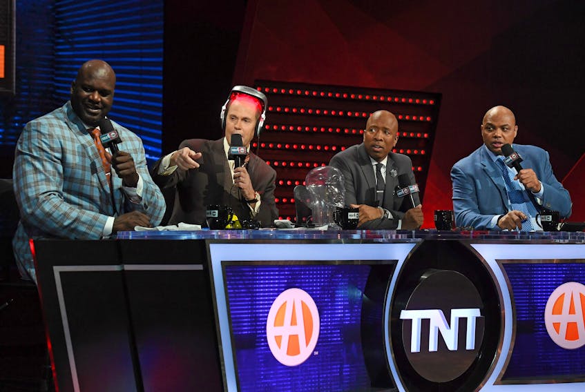 TNT's Inside the NBA team (L-R) NBA analyst Shaquille O'Neal, host Ernie Johnson Jr., wearing an iGrow laser-based hair-growth helmet, and NBA analysts Kenny Smith and Charles Barkley.