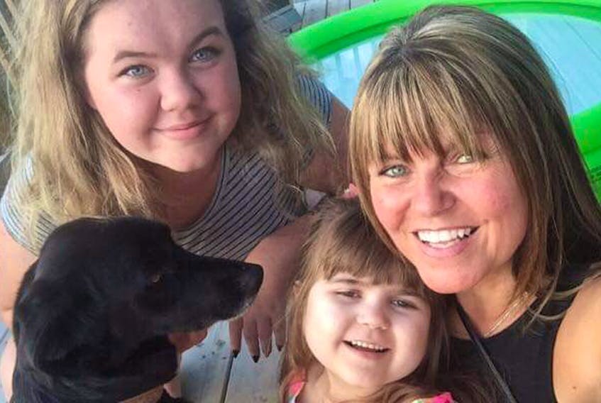 Colleen Kennedy is pictured with her daughters, Kayla Kennedy, now 18, and Olivia Reardon, and the family’s dog, Chloe, on Aug. 27, 2018, as the family celebrated Olivia’s ninth birthday.