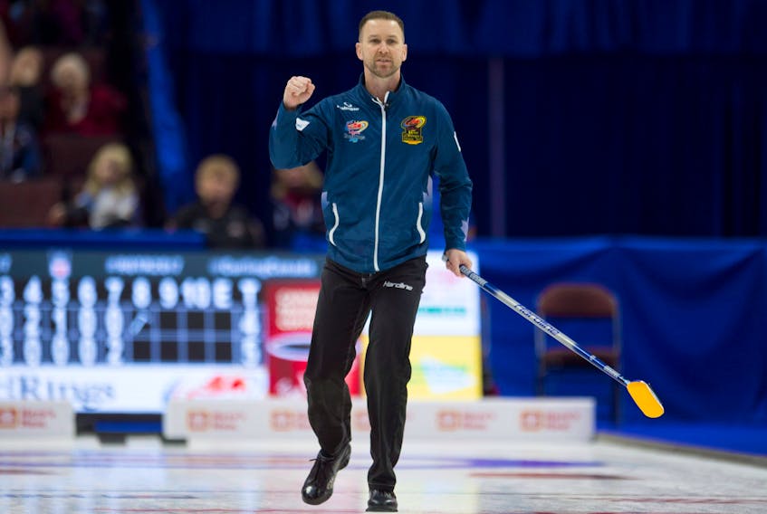 Skip Brad Gushue pumps his fist after scoring four in the eighth end during his Roar of the Rings Canadian Olympic Curling Trials game against John Morris Monday in Ottawa.