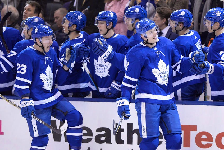 Justin Holl (right) and Travis Dermott (23), along with three other members of the 2017-18 Calder Cup-champion Toronto Marlies blue-line, have suddenly been entrusted with holding the fort on the Maple Leafs’ back end with Jake Muzzin joining Morgan Rielly and Cody Ceci on the injured list.  Frank Gunn/CP