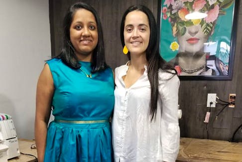 Prajwala Dixit (left) stands with Constanza Safatle, project co-ordinator at Creative Sewing Atelier after channeling Frida Kahlo's energy (shown in background portrait). — Contributed