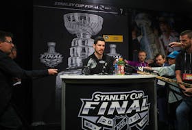 Pittsburgh Penguins' Sidney Crosby talks to reporters.