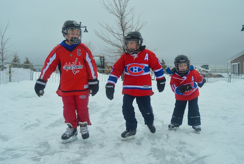 From left, Cale Buchanan, Caiden Romeo and Logan Romeo are shown wearing their favourite hockey jerseys and skating at the new outdoor rink at Open Hearth Park in Sydney. The rink opened to the public on Saturday, much to the pleasure of the local community.