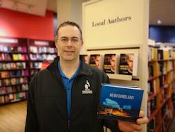 St. John’s based photographer, Michael Winsor, with his new book of photography, ‘Lost in Newfoundland.’ - Andrew Waterman/The Telegram