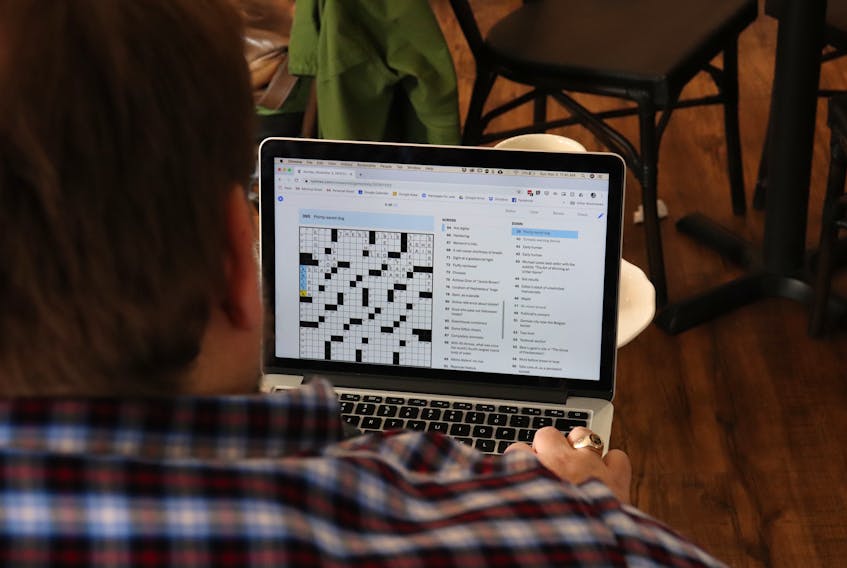 In a Halifax coffee shop, Paul St-Amand concentrates on filling in the New York Times crossword puzzle. Dedicated to his goal of completing 3,653 crosswords before Dec. 29, 2019 in honour of his late father, he works on them whenever he has a spare minute.