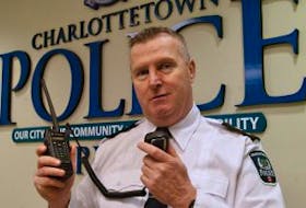 ['Gary McGuigan, deputy chief of operaitons with Charlottetown Police Services, holds up a new digital radio now being tested by officers. The new signal cannot be deciphered by scanner radios used by the public. ']