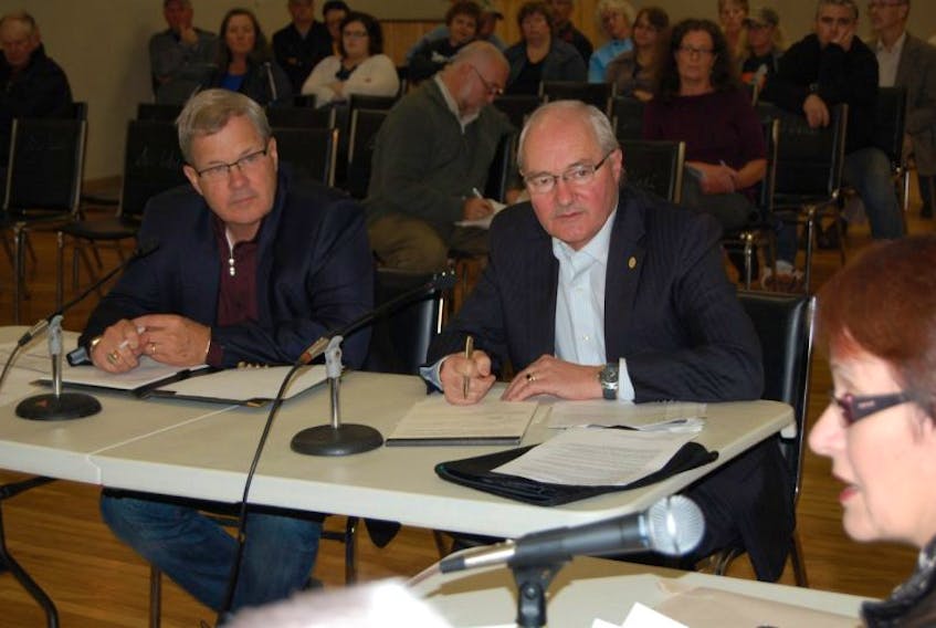 Federal MPs Lawrence MacAulay, left, and Wayne Easter deliver objections to EI changes during a provincial standing committee meeting packed in Souris Wednesday night. At right is standing committee member Paula Biggar.