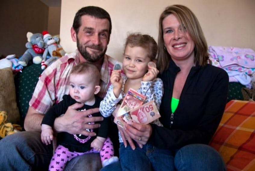 <span>Bill MacNamara and June Bond pose for a photo with the their daughters Gabrielle (6 months) and Abigail (3). The couple received two $50 bills and two $5 coins randomly from a stranger.</span>