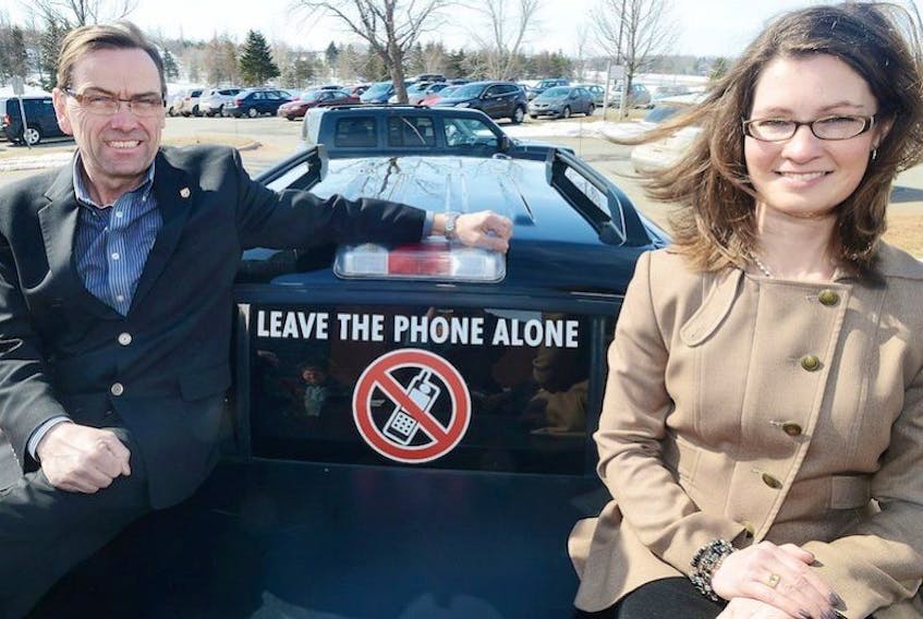 Minister Robert Vessey, left, and Amanda Dean, vice president Atlantic Insurance Bureau of Canada, were promoting the Leave the Phone Alone campaign. Islanders are encouraged to pledge not use their mobile devices while driving.
