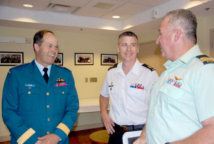 Canada's Chief of Defence Staff Gen. Tom Lawson, left, shares a laugh with Capt. David Ellis, right, and petty officer (first class) Robert Patenaude. Lawson was in Charlottetown Wednesday visiting with Canadian Armed Forces personnel at HMCS Queen Charlotte.