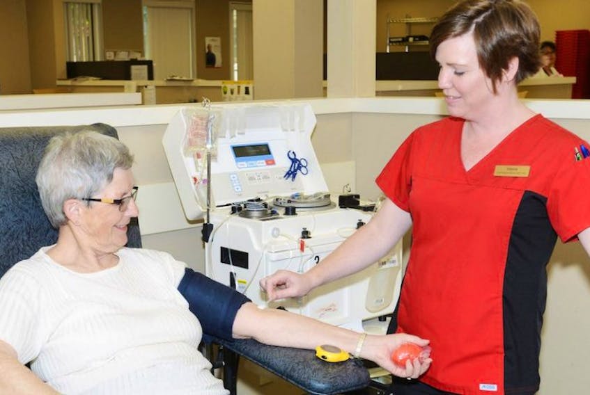 FILE PHOTO: Tanya Herrell, right, phlebotomist, prepares Faye Larkin for a donation at the Canadian Blood Services office in Charlottetown.