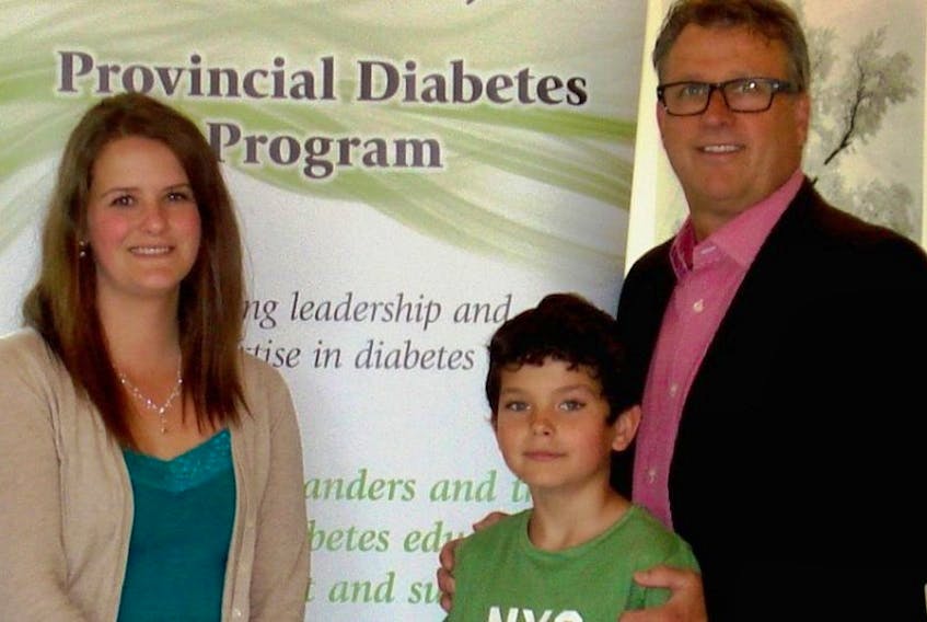 Tawnya Matheson and her son, Bradley Butterfield, who has Type 1 diabetes, join P.E.I. Health and Wellness Minister Doug Currie for an announcement that the provincial government will be helping to offset the cost of insulin pumps for eligible families.
