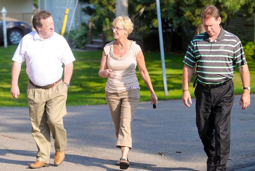 Charlottetown Mayor Clifford Lee, left, city councillor Melissa Hilton and Progressive Conservative MLA James Aylward walk to a meeting with residents of the Brows Lane neighbourhood that are concerned with drug activity in the area. The meeting, held in a private home, was closed to the local media.&nbsp;
