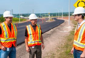 <p class="p1">Mark Sherren, left, regional engineer, Transportation Minister Robert Vessey and Matthew Fortier, engineering technical officer, look over the new roundabout at the Upton Road in Charlottetown.</p>
