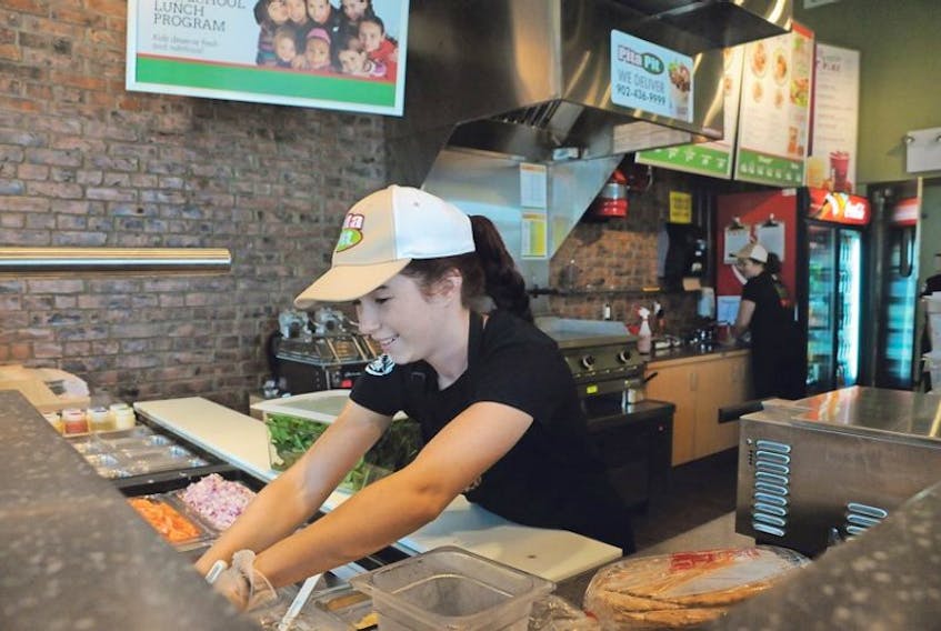 <span>Brittany Gallant of Summerside's new Granville Street Pita Pit location was busy Thursday getting ready for the store's first day in business on Friday. This is the chain's second Prince Edward Island location and the first in Summerside.</span>