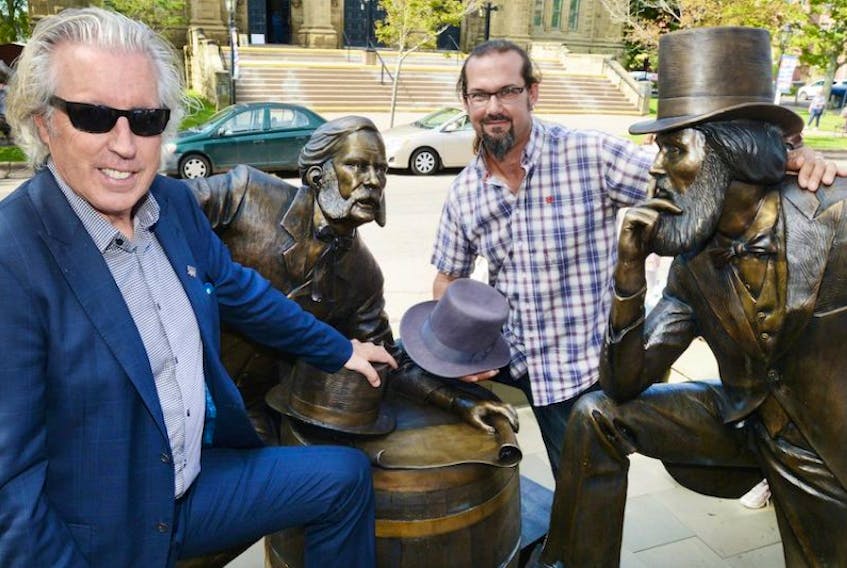 <p class="p1">Kevin Murphy, left, and artist Nathan Scott, stand with the newly unveiled bronze statue of two Fathers of Confederation named John Hamilton Gray. The statue, situated on Great George Street was unveiled during a ceremony held Thursday.</p>