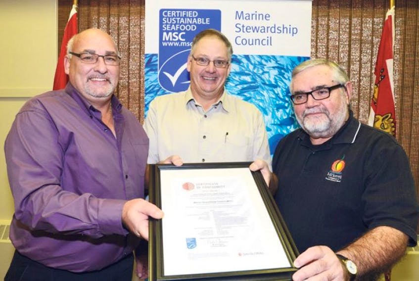 Jeff Malloy, left, president of the P.E.I. Seafood Processors Association, Craig Avery, president of the P.E.I. Fishermen’s Association, and Ed Frenette, right, of the Mi’kmaq Confederacy of P.E.I., display the Marine Stewardship Council’s certificate for conformity.