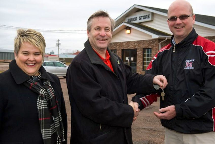 Raeanne Adams, chairwoman, and Kevin Porter, executive director, right, of Community Inclusions Ltd., receive the keys to the former liquor store property in O’Leary from Robert Henderson, minister responsible for the P.E.I. Liquor Control Commission.