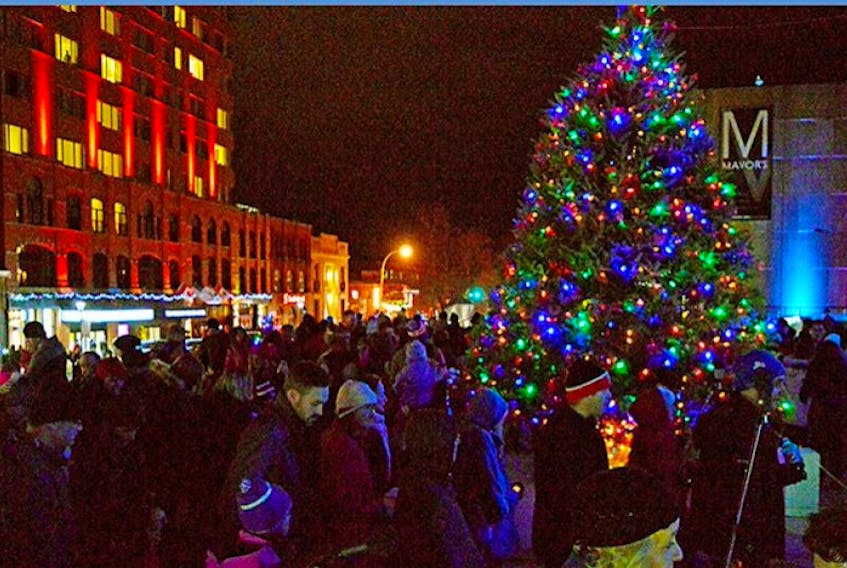 ['Crowds move past the 2015 Wintertide tree and lights display in downtown Charlottetown Friday on the upper concourse of the Confederation Centre of the Arts. The tree had just been lit and the event was moving to free cookies and hot chocolate in the centre.']