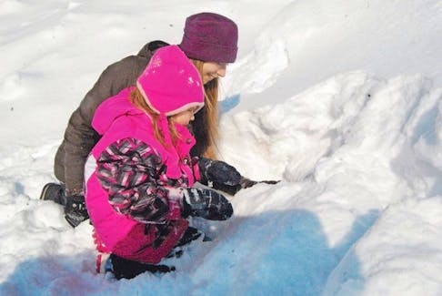 Four-year-old Ellen Jadis, who attends Abegweit First Nation Early Years Centre in Scotchfort, digs excitedly with Hanna Hameline, Sierra Club P.E.I. Wild Child co-ordinator, to create a cozy cave home where animals might live.